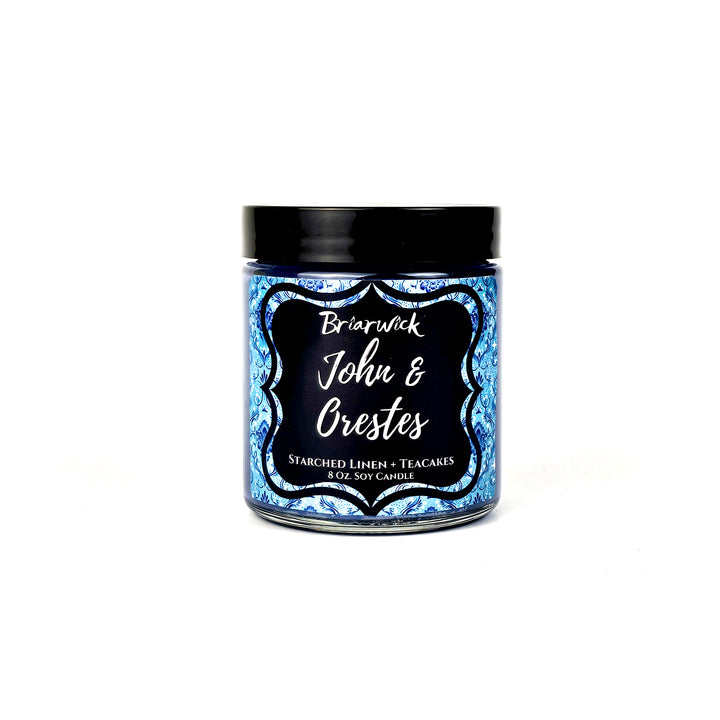 a jar of blue and black candles on a white background