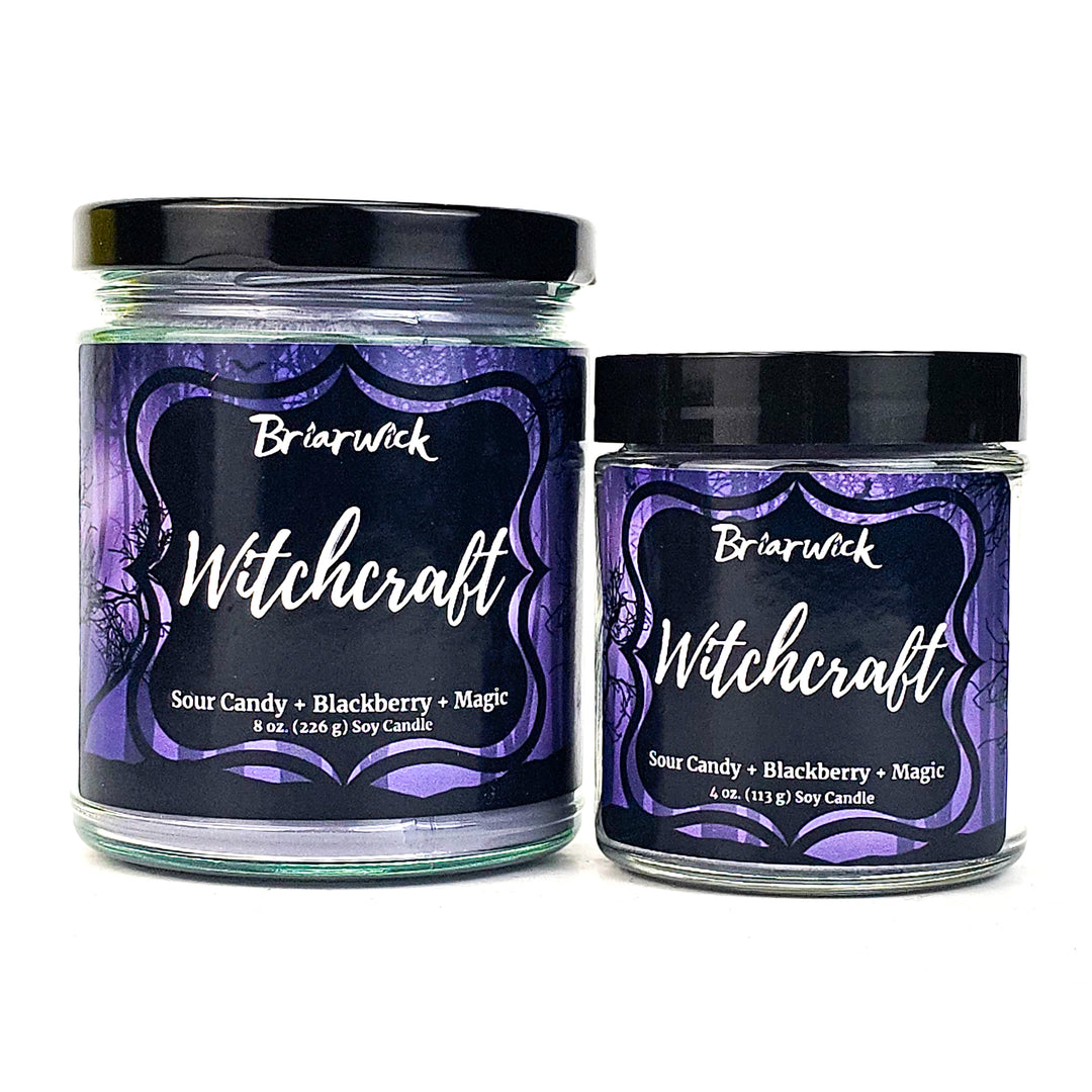 two jars of witchcraft candles sitting next to each other