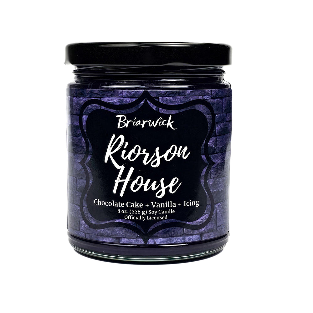 Riorson House 8oz indigo candle with purple brick design on a white background