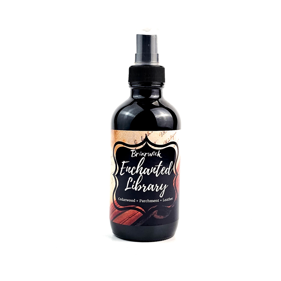 Enchanted Library 4oz Linen Spray with an open book design on a white background