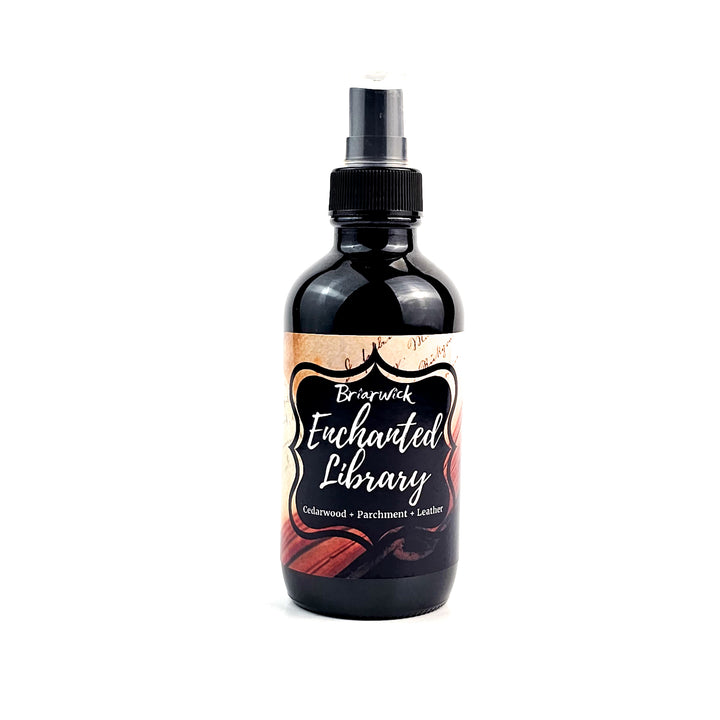 Enchanted Library 4oz Linen Spray with an open book design on a white background