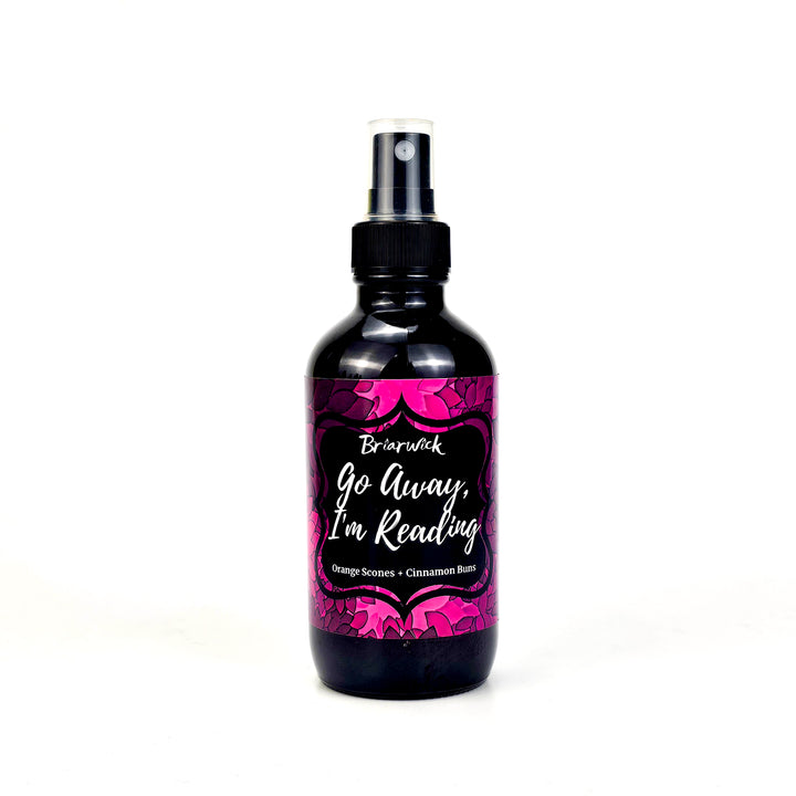 Go Away, I’m Reading 4oz Linen Spray with magenta floral design on a white background
