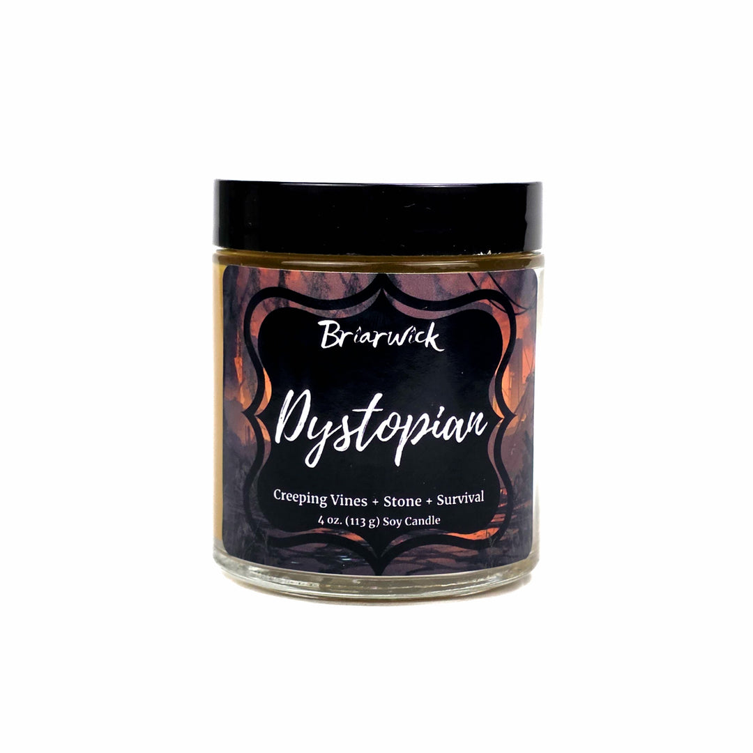A 4 oz soy candle in a clear glass jar with a black lid on a white background and a dark label reading 'Briarwick Dystopian'. The label features a dark graphic with orange and red tones.