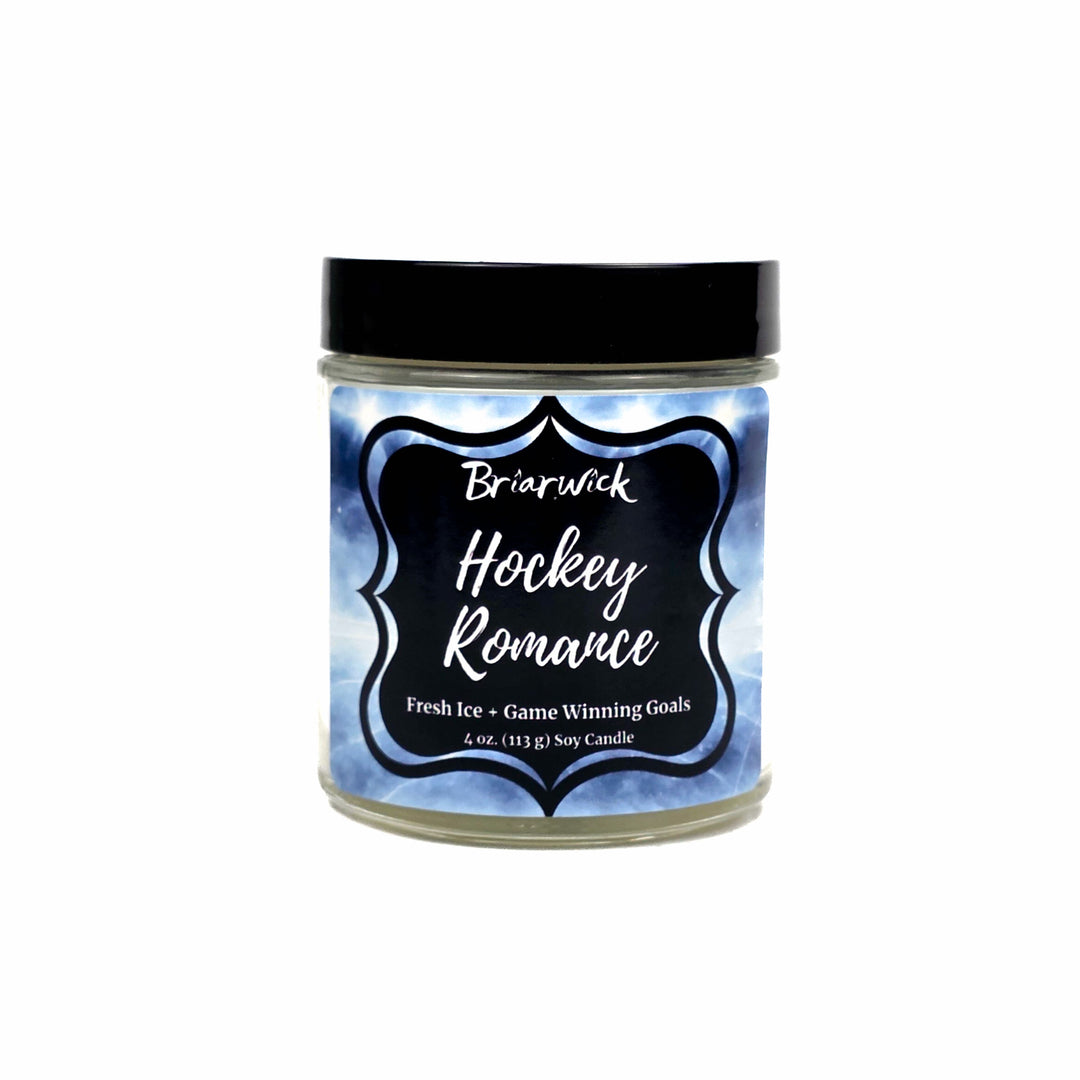 A 4 oz soy candle in a clear glass jar with a black lid on a white background, featuring a blue and white ice-patterned label with the text 'Briarwick Hockey Romance'.