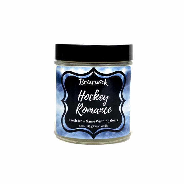 A 4 oz soy candle in a clear glass jar with a black lid on a white background, featuring a blue and white ice-patterned label with the text 'Briarwick Hockey Romance'.