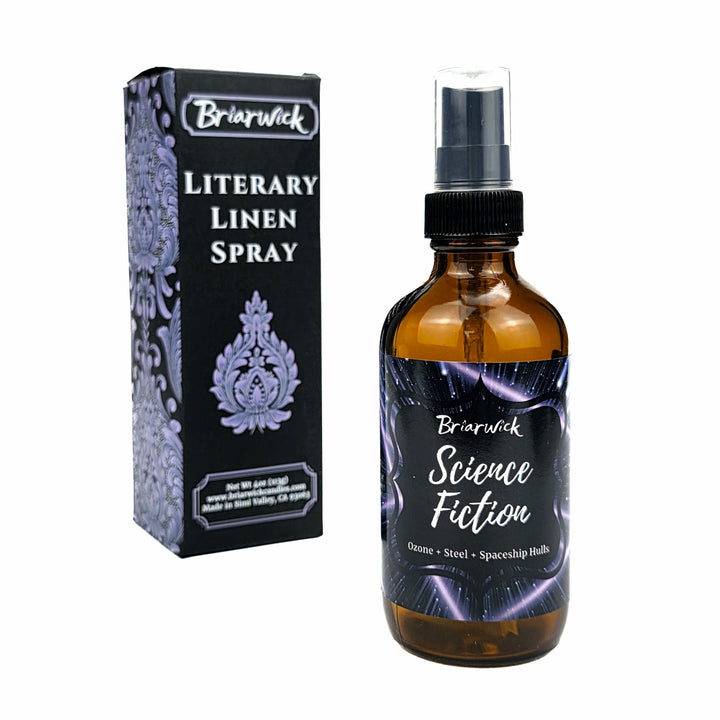 An amber glass spray bottle labeled 'Briarwick Science Fiction Literary Linen Spray' stands next to its black and lavender patterned retail box on a plain white background.