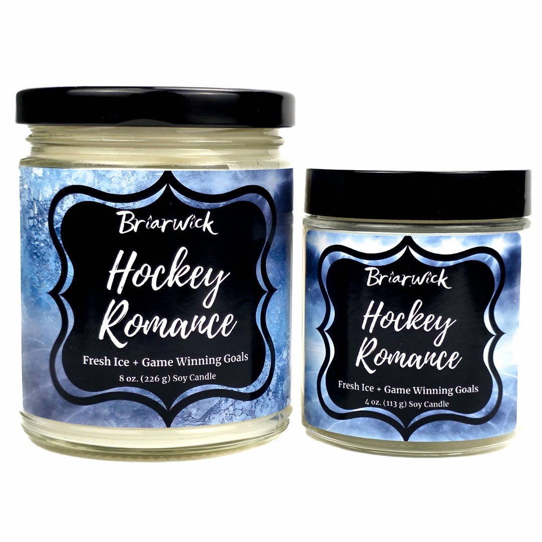 Two jars of Briarwick 'Hockey Romance' soy candles on a white background, one 8 oz and one 4 oz, both with black lids and blue ice-patterned labels.