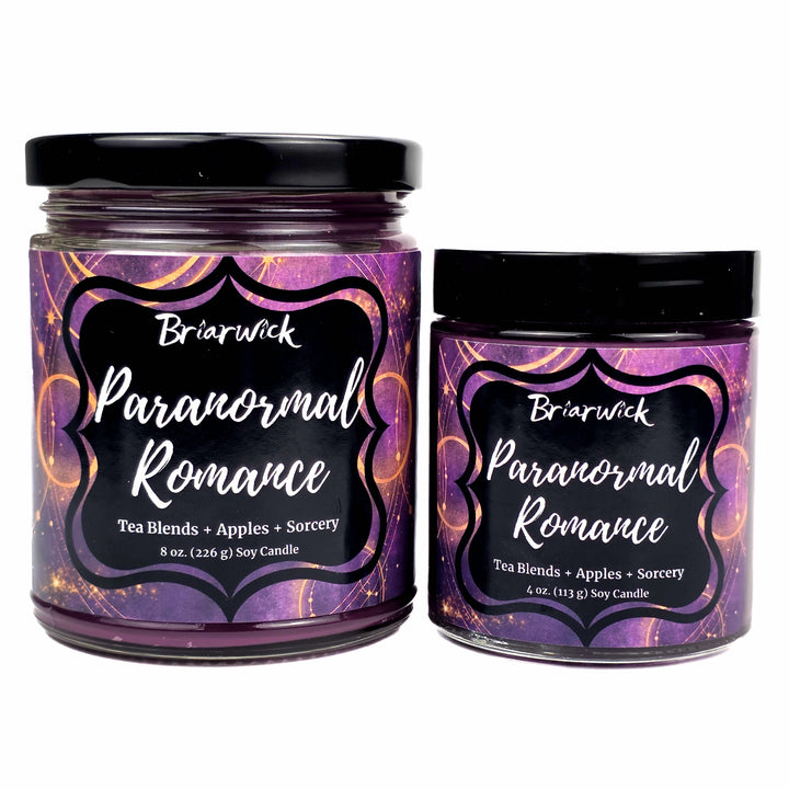 Two jars of Briarwick 'Paranormal Romance' soy candles on a white background, one 8 oz and one 4 oz, both with purple labels and black lids.