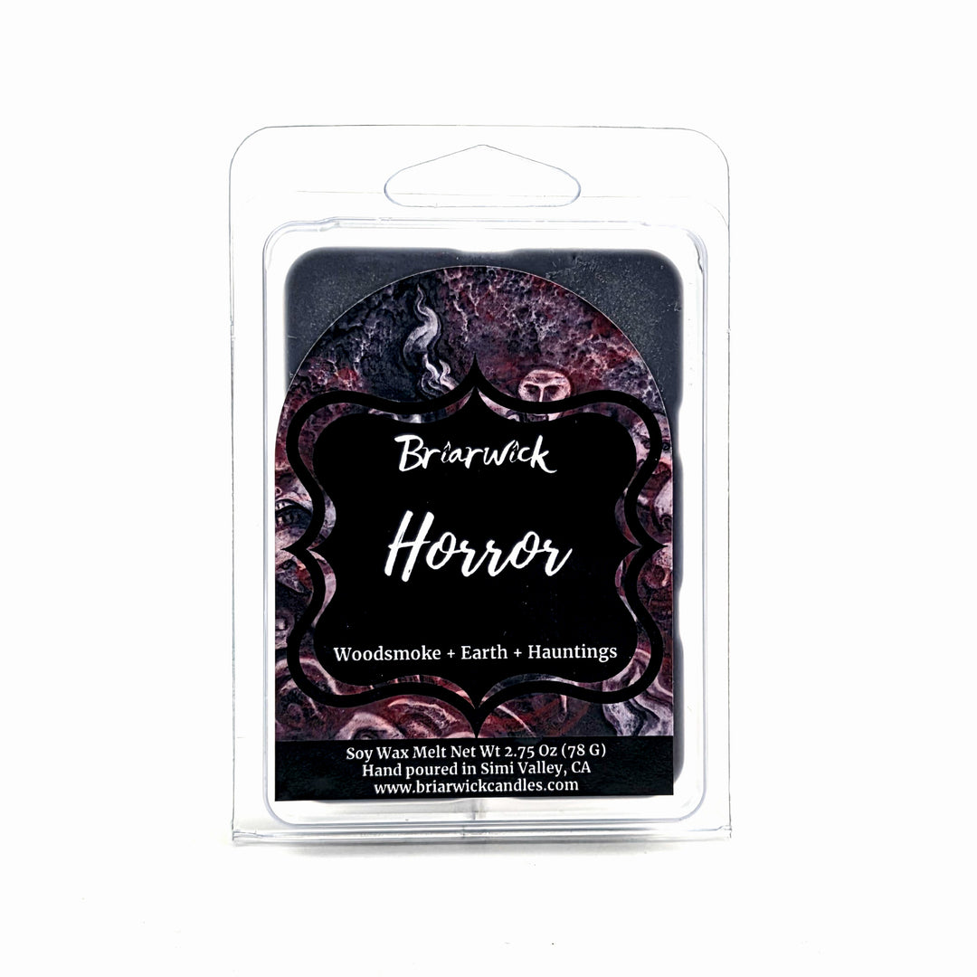 Briarwick Horror soy wax melt in a clear plastic clamshell package with a black and dark purple label featuring gothic text and decorative patterns.