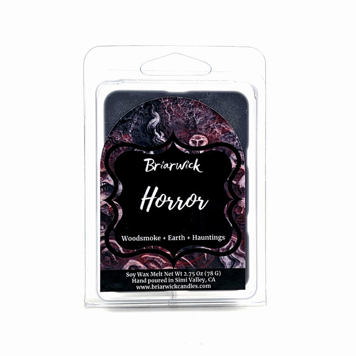 Briarwick Horror soy wax melt in a clear plastic clamshell package with a black and dark purple label featuring gothic text and decorative patterns.