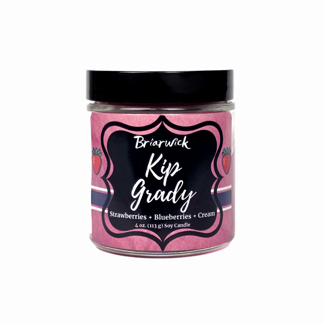 Jar of Briarwick Kip Grady candle with pink label on white background