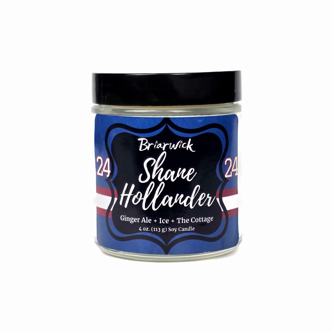 Jar of Shane Hollander candle with blue label on a white background