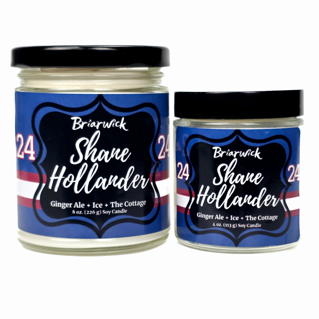 Two jars of Briarwick Shane Hollander candles with blue labels on a white background