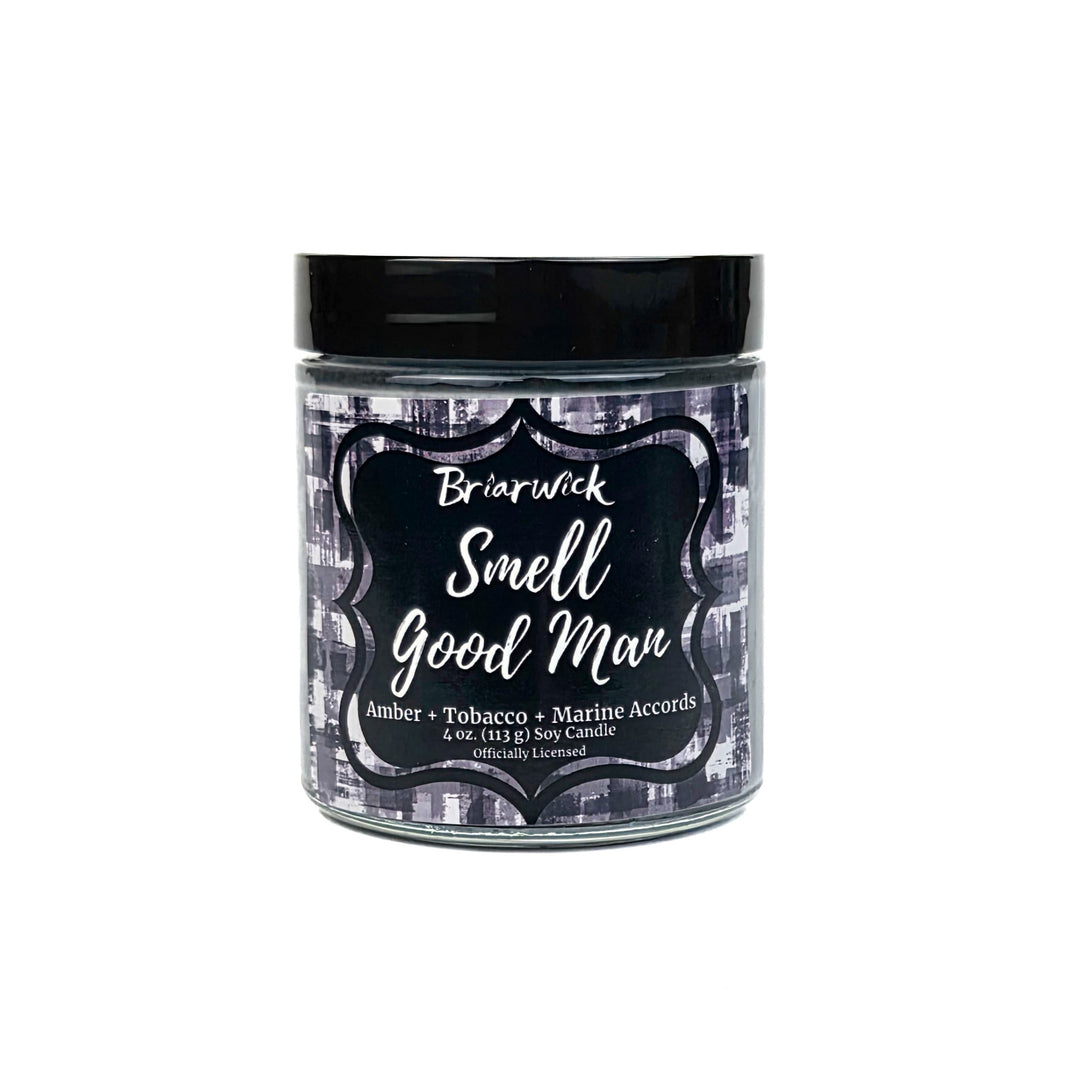 Jar of candle with black lid and label on a white background