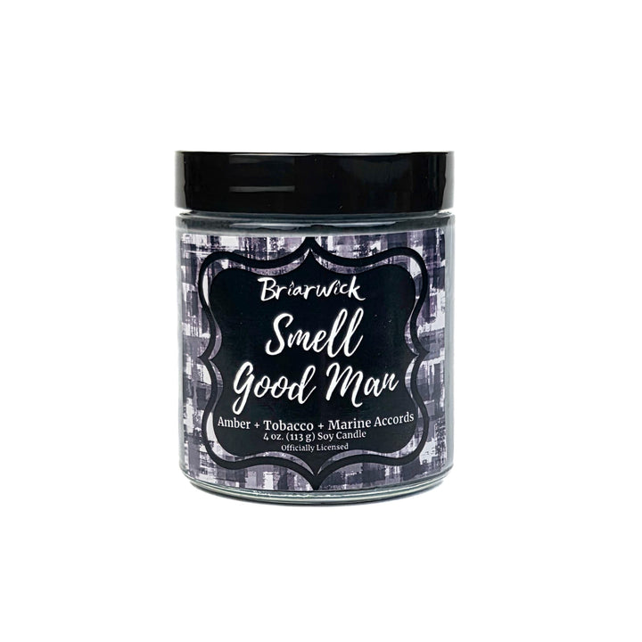 Jar of candle with black lid and label on a white background