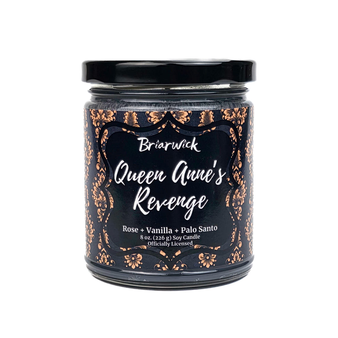 Candle jar labeled 'Queen Anne's Revenge' with decorative black and gold design on a white background