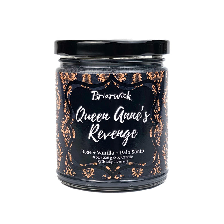 Candle jar labeled 'Queen Anne's Revenge' with decorative black and gold design on a white background