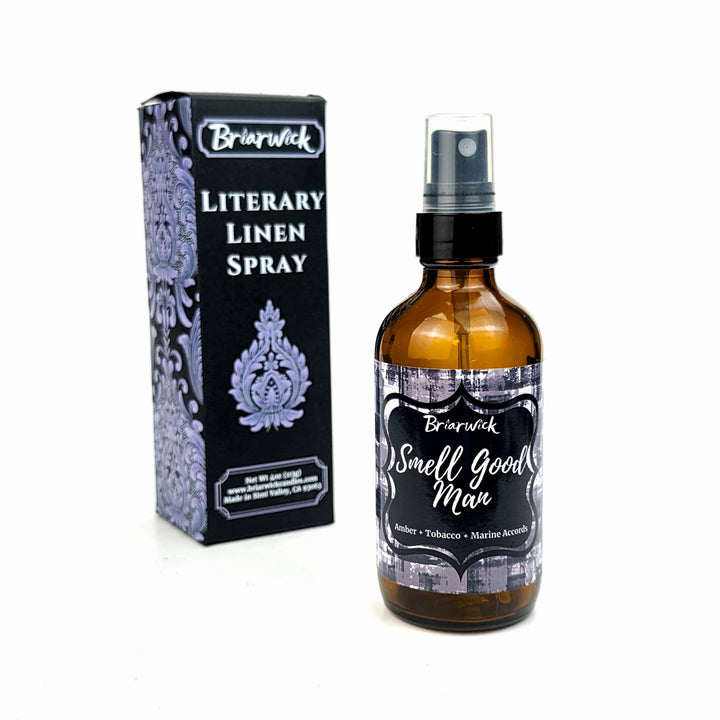 Bottle of 'Smell Good Man' linen spray with packaging on a white background