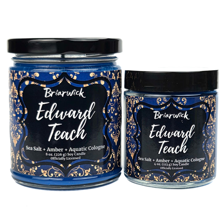 Two candles with decorative labels featuring the name 'Edward Teach' on a white background.
