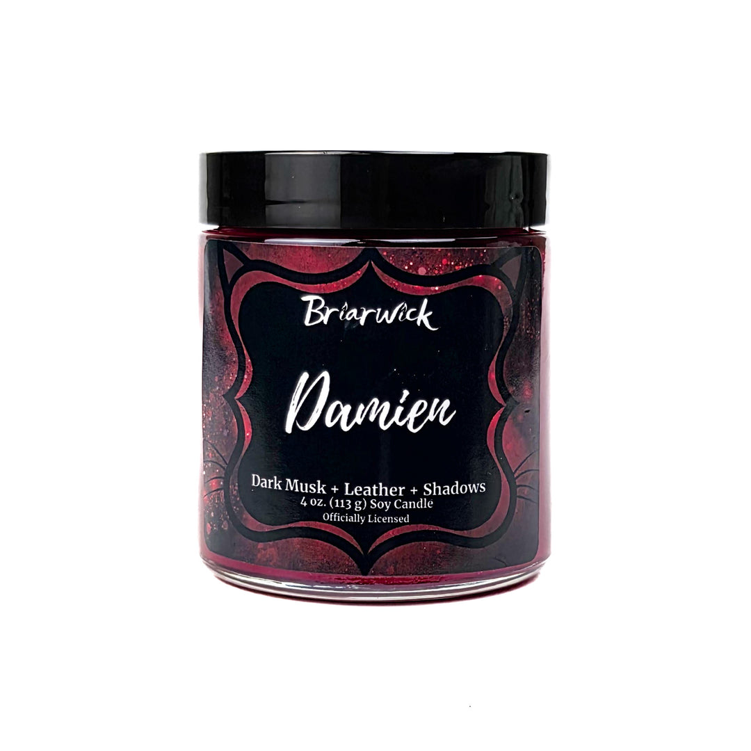 A red Damien 4oz candle jar by Briarwick on a white background