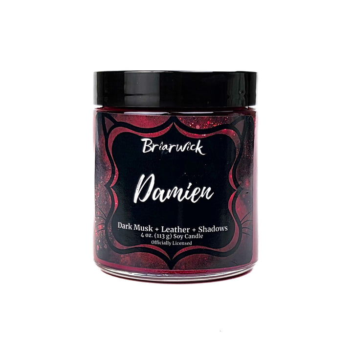 A red Damien 4oz candle jar by Briarwick on a white background