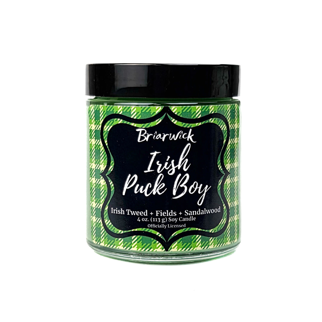 A green Irish Puck Boy 4 oz candle by Briarwick on a white background