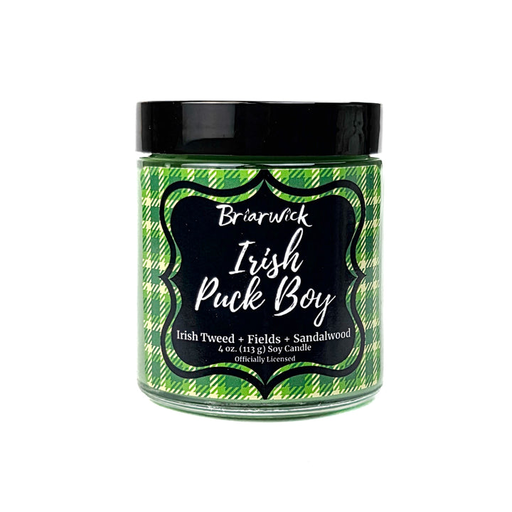 A green Irish Puck Boy 4 oz candle by Briarwick on a white background