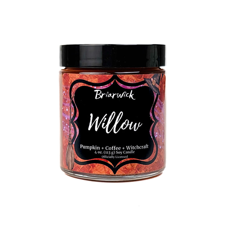 An orange Willow 4oz candle jar by Briarwick on a white background