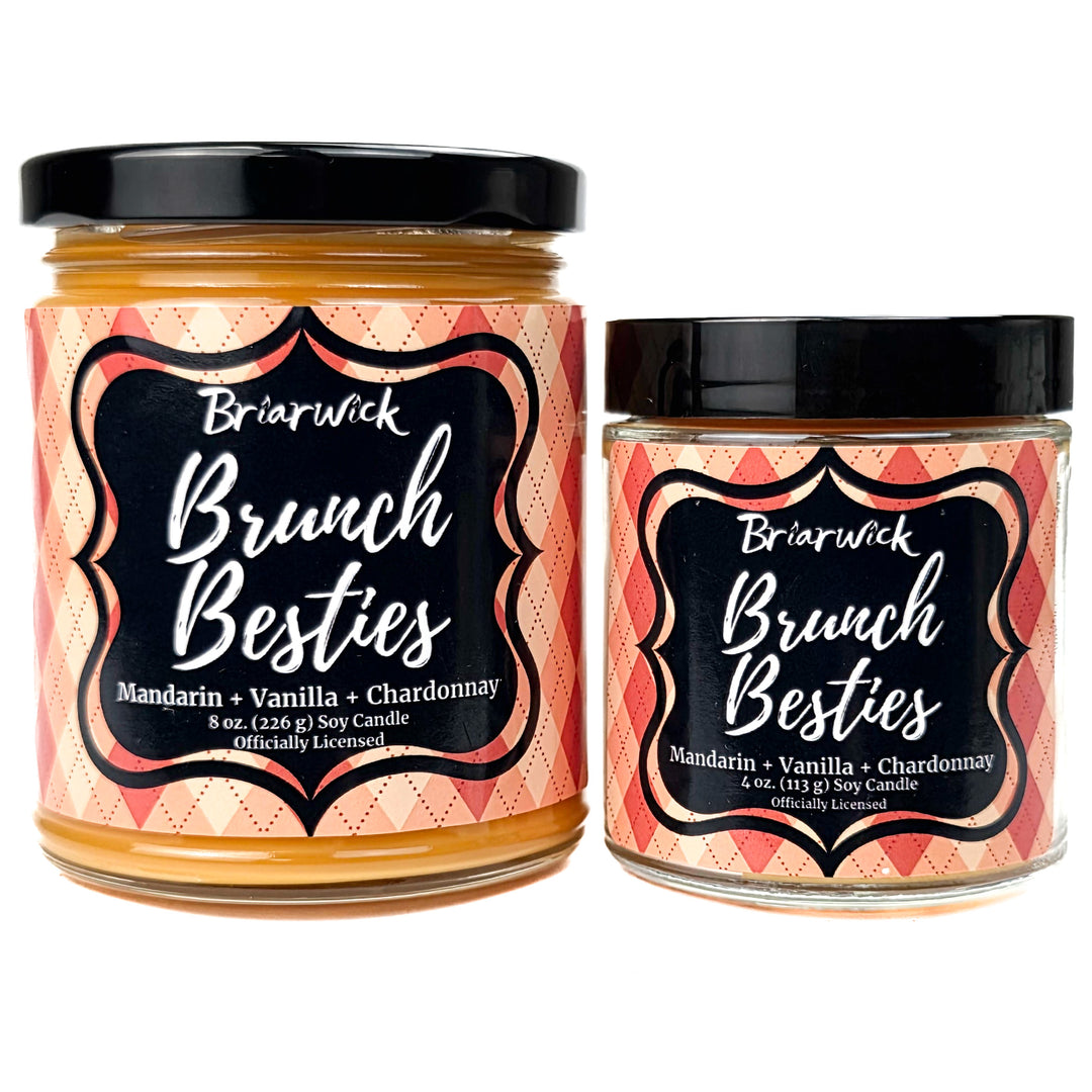 2 orange Brunch Besties candles on a white background