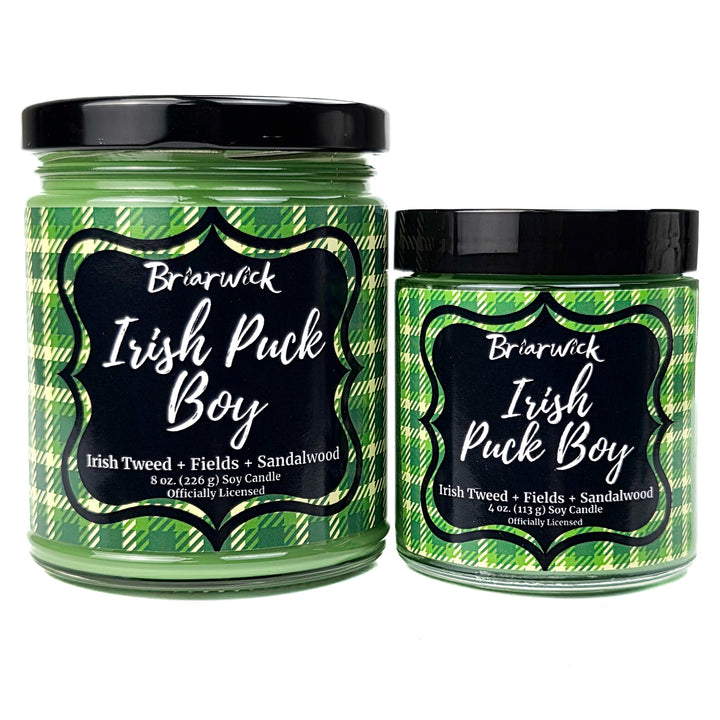 2 green Irish Puck Boy candles on a white background
