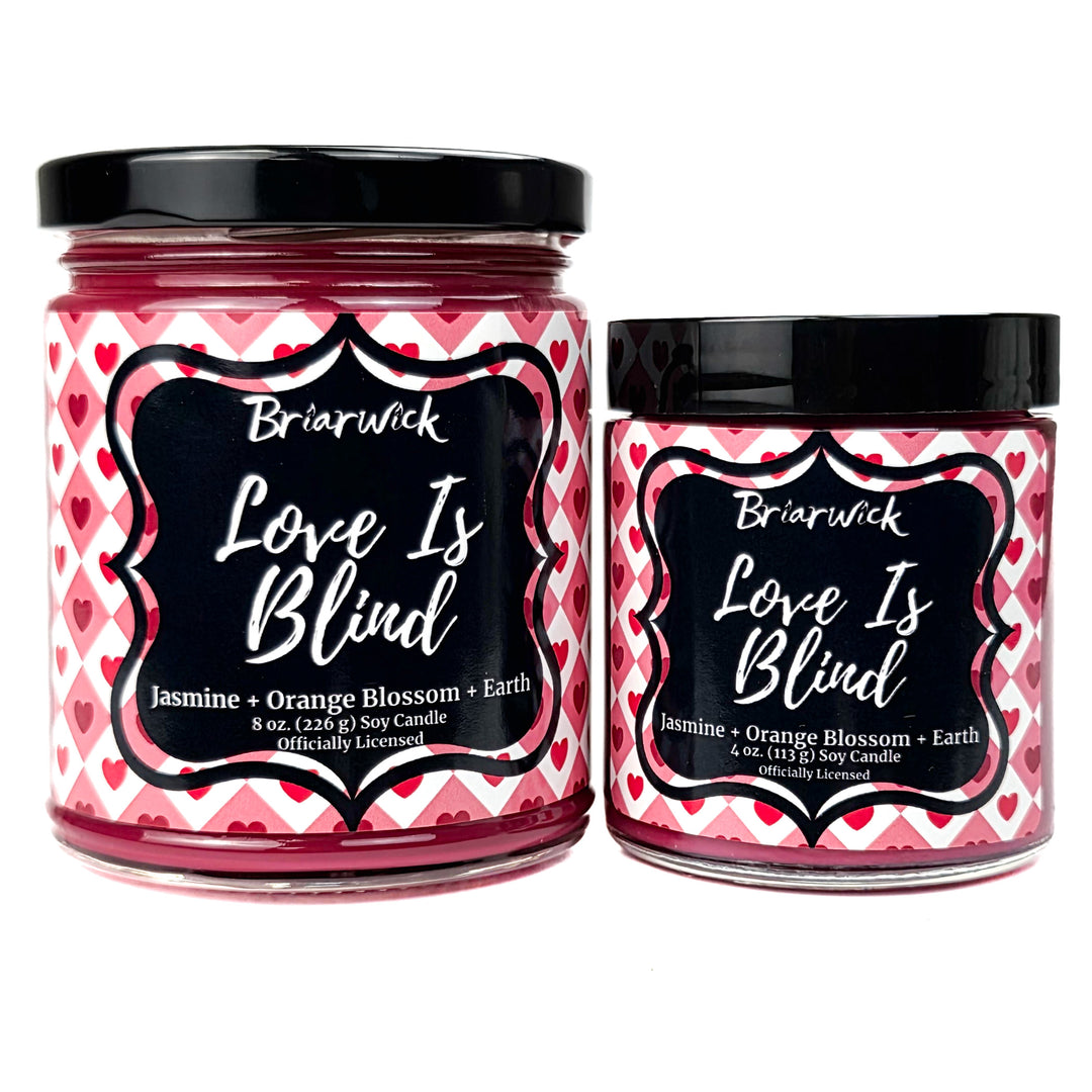 2 red Love Is Blind candles on a white background