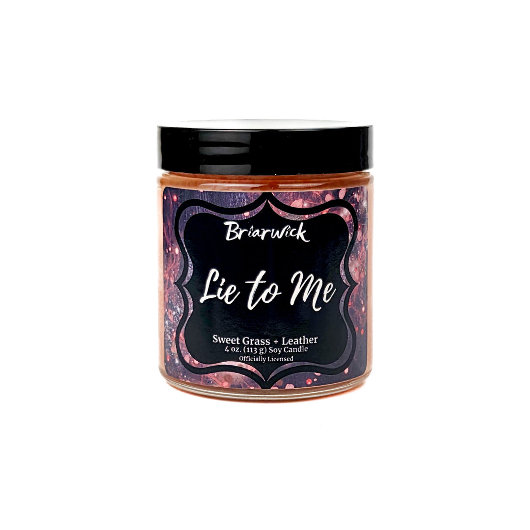 Briarwick 4oz soy candle in glass jar on a white background. Has black and red label with scent name Lie to Me