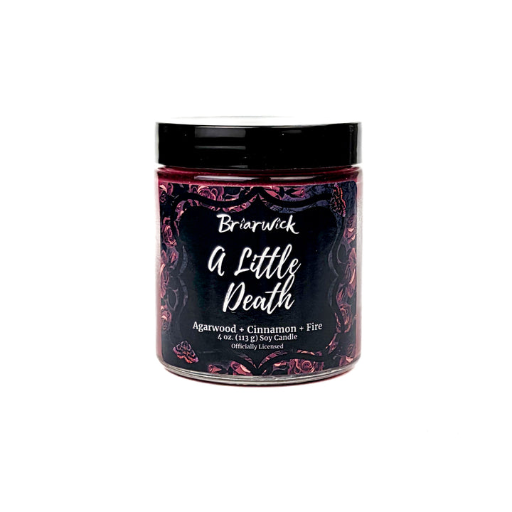 Briarwick 4oz soy candle in glass jar on white background. Red rose label has scent name A Little Death