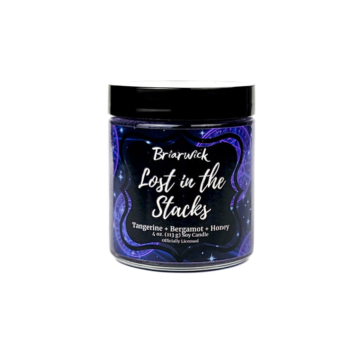 Briarwick 4oz soy candle in glass jar on white background. Indigo label has scent name Lost in the Stacks