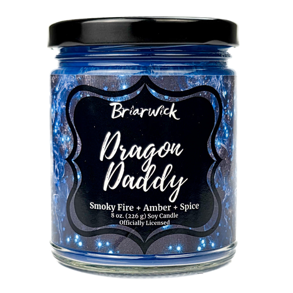 Jar of Briarwick Dragon Daddy candle with blue glittery label