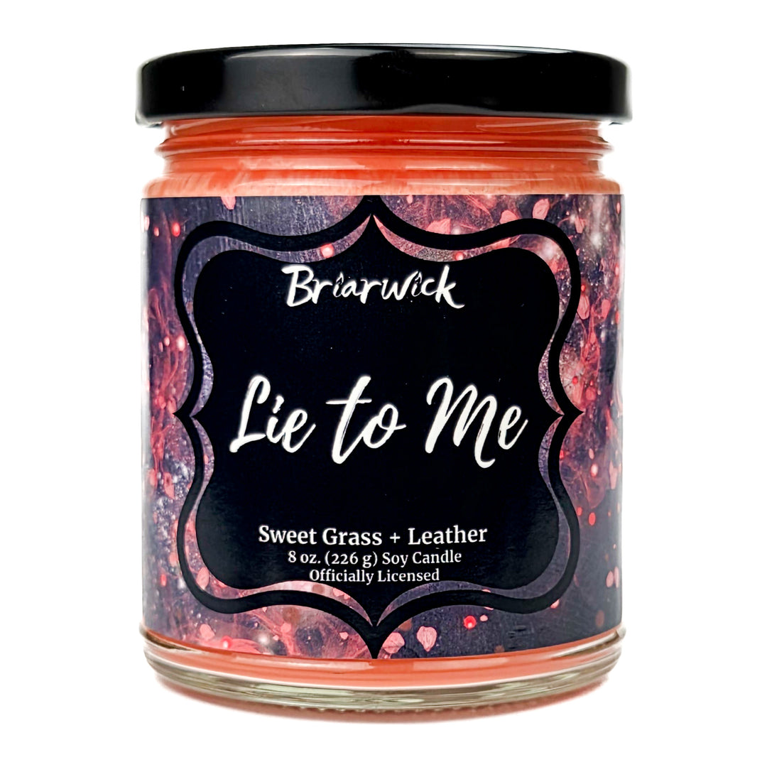 Briarwick 8oz soy candle in glass jar on a white background. Has black and red label with scent name Lie to Me