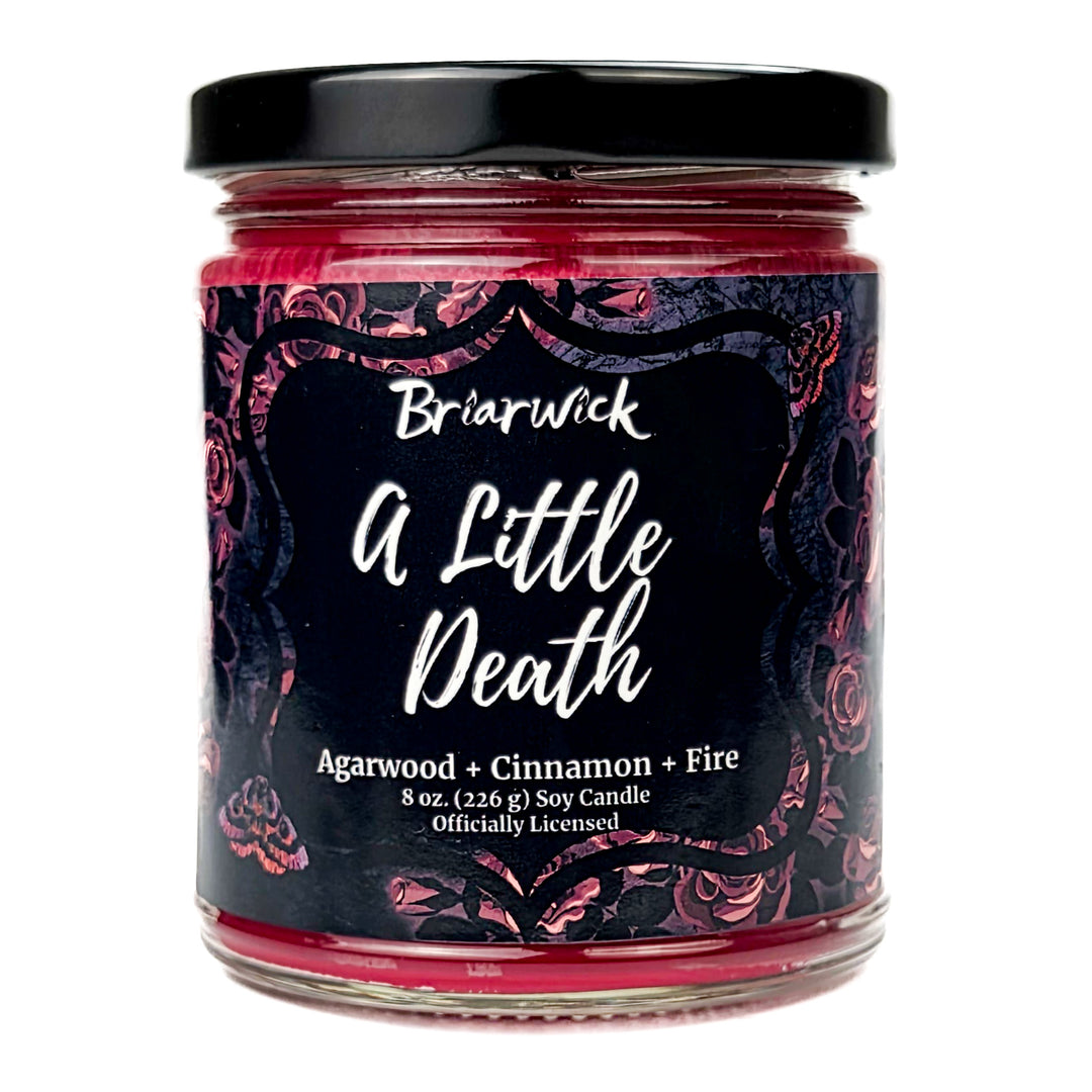 Briarwick 8oz soy candle in glass jar on white background. Red rose label has scent name A Little Death
