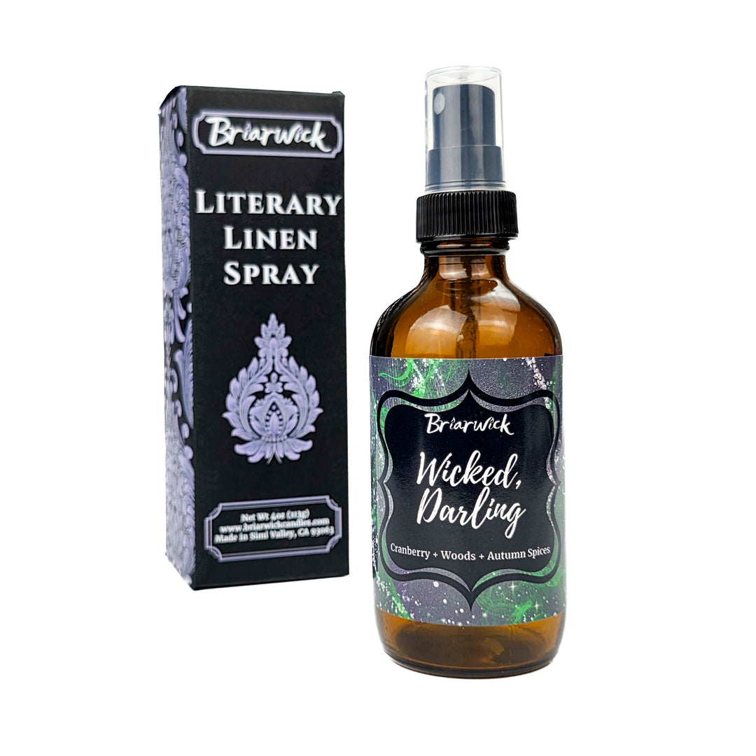 Briarwick Literary Linen Spray bottle and packaging on a white background. Amber bottle has green label with scent name Wicked, Darling