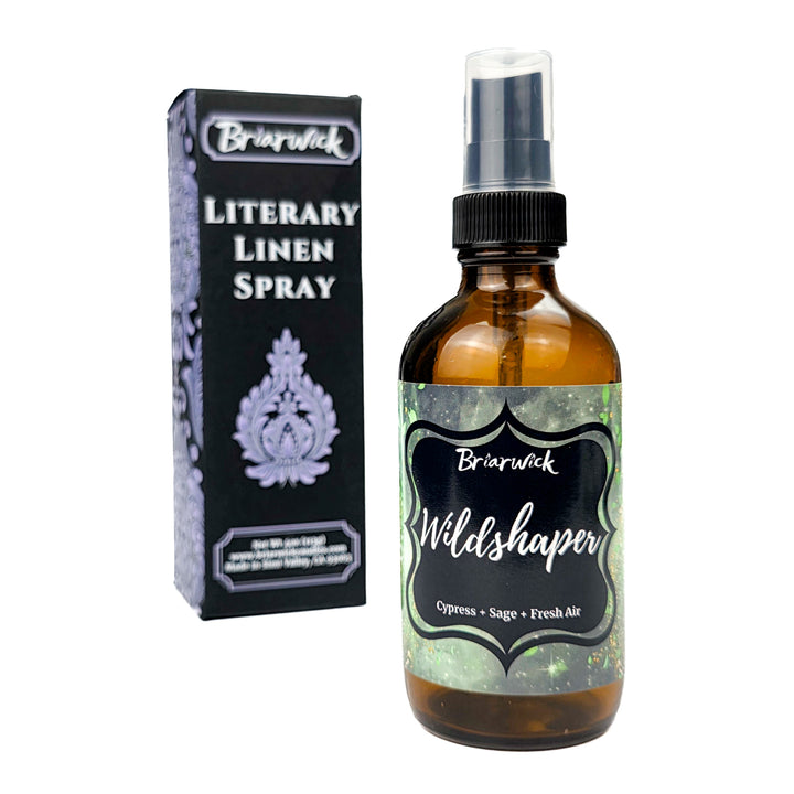 Briarwick Literary Linen Spray bottle and packaging on a white background. Amber spray bottle has green label and scent name Wildshaper