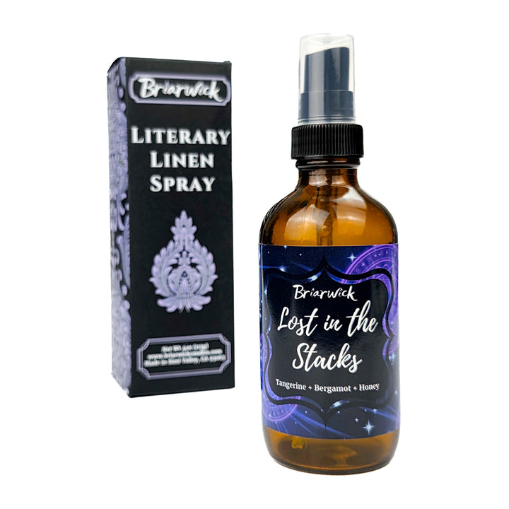 Briarwick Literary Linen Spray bottle and packaging on a white background. Amber bottle with indigo label and scent name Lost in the Stacks