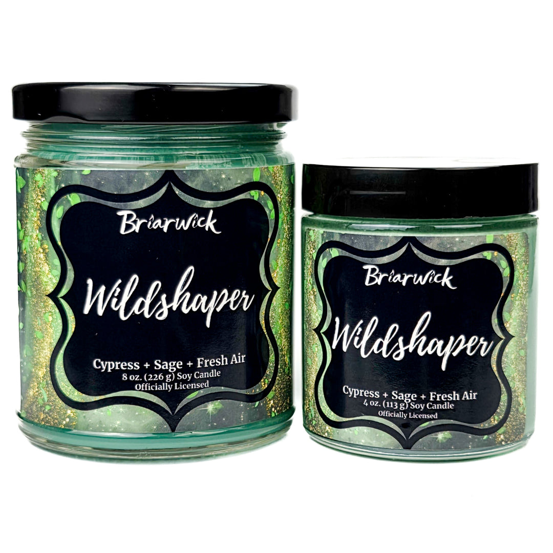 Two Briarwick Wildshaper candles with green glittery labels on a white background