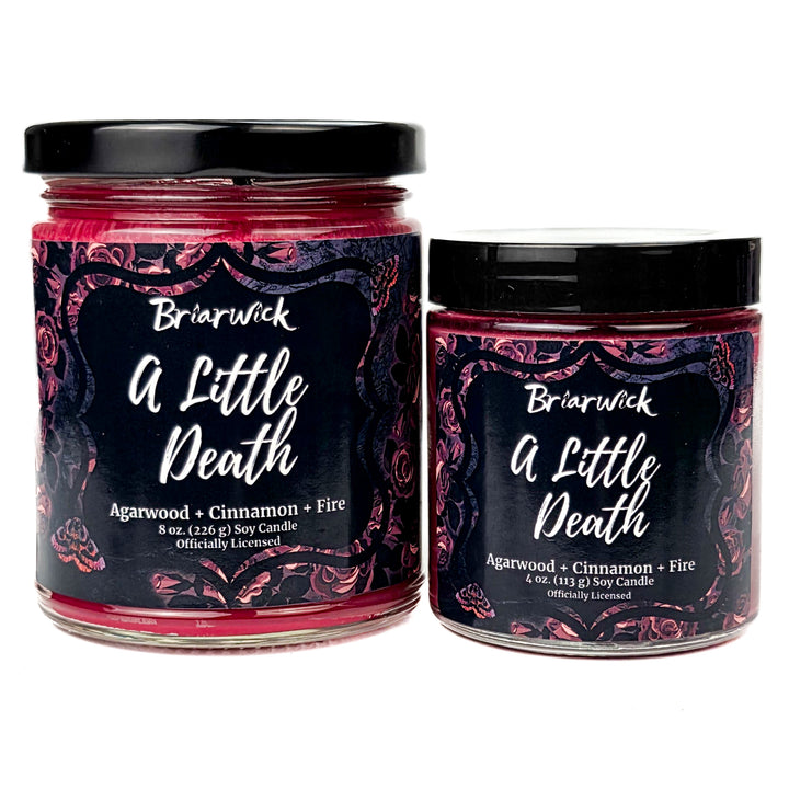 Two Briarwick 'A Little Death' candles with black lids on a white background