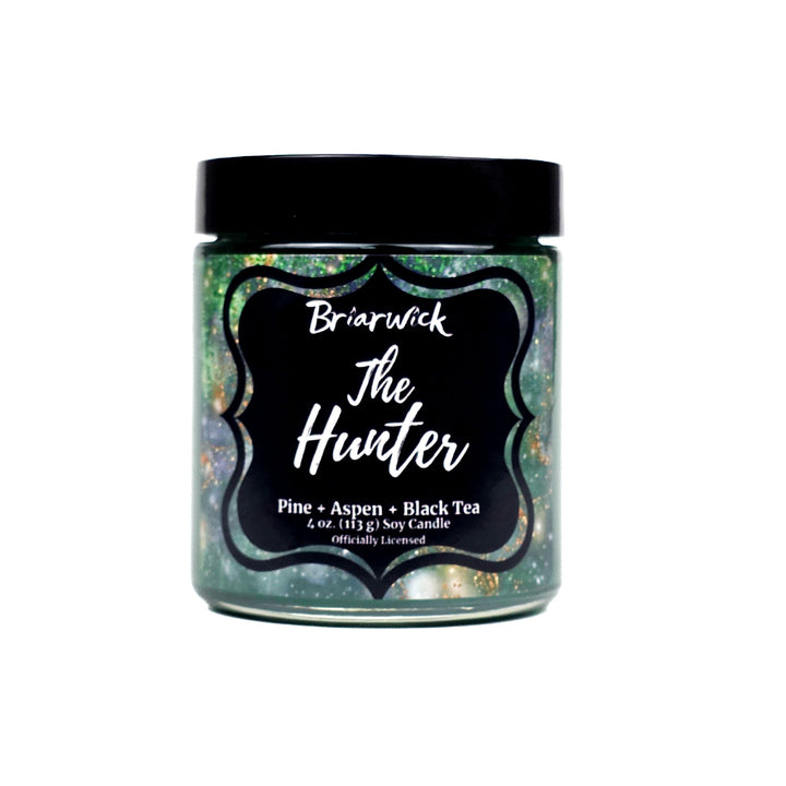 Jar of 'The Hunter' candle with a black lid and label on a white background