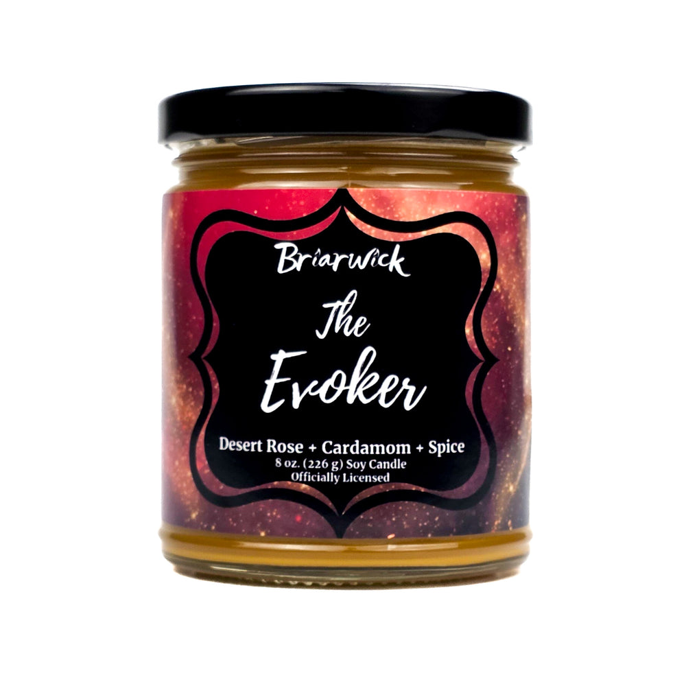 Jar of candle labeled 'The Evoker' with a colorful label on a white background