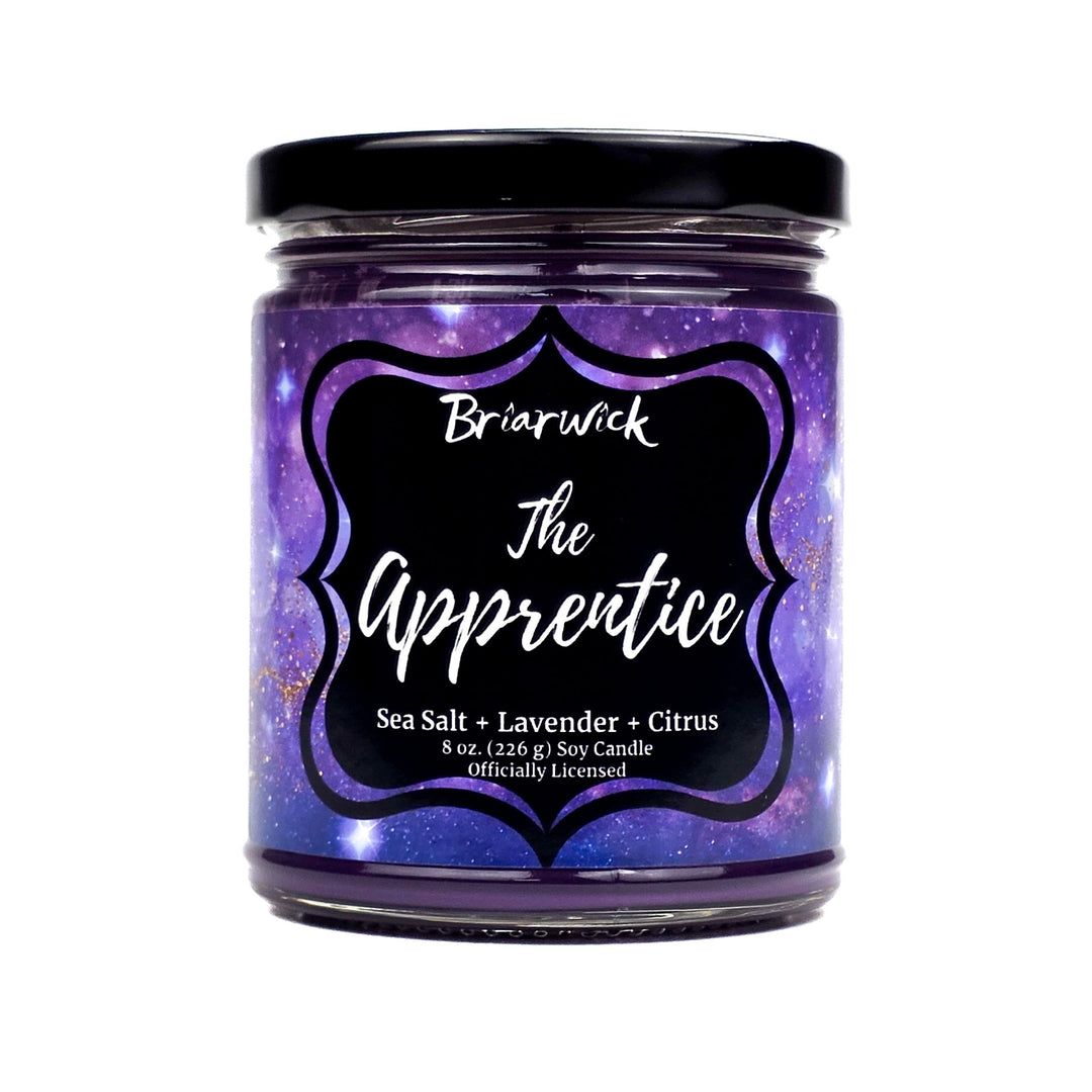 Candle jar labeled 'The Apprentice' by Briarwick with a purple label on a white background
