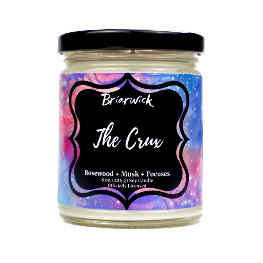 Candle jar with a colorful label featuring the name The Crux on a white background.