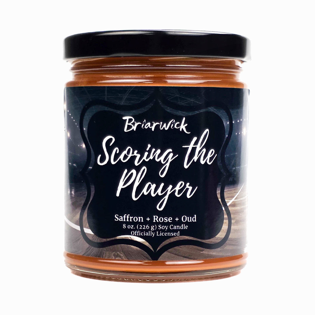 Jar of candle labeled 'Scoring the Player' by Briarwick on a white background