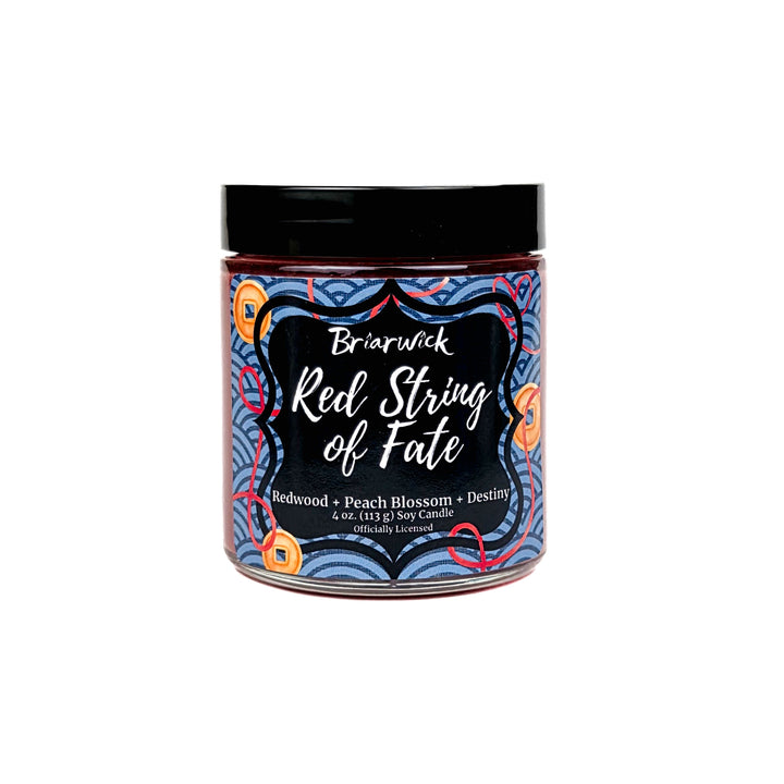 Jar of candle labeled 'Red String of Fate' by Briarwick on a white background