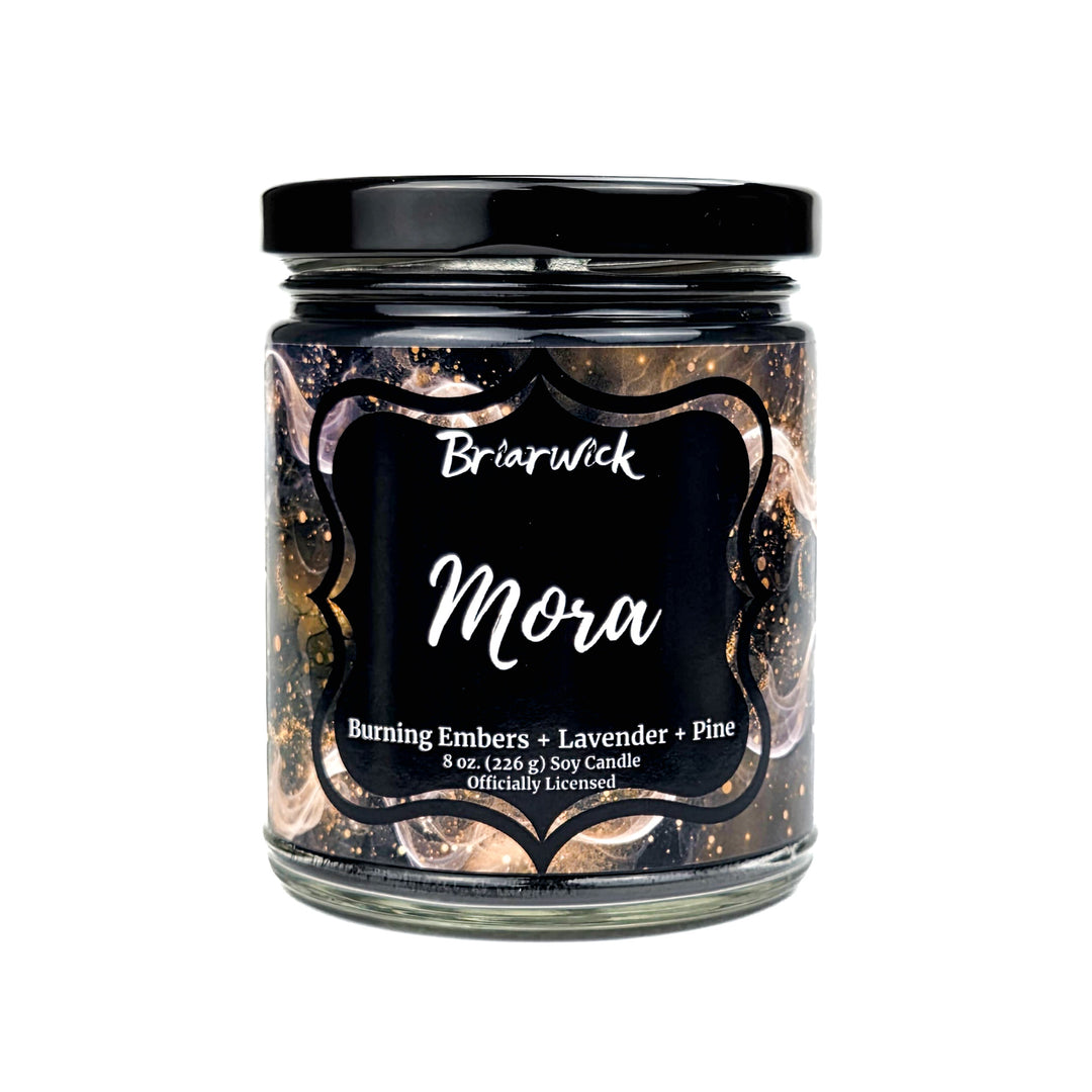 Candle jar labeled 'Mora' by Briarwick with decorative black lid on a white background