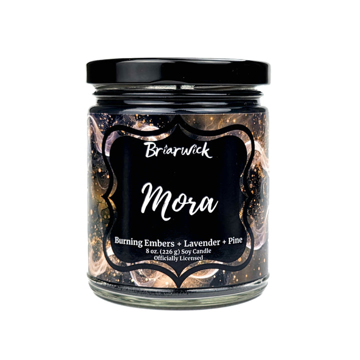 Candle jar labeled 'Mora' by Briarwick with decorative black lid on a white background